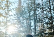 겨울철 산책 코스 person in black jacket standing in front of trees during daytime