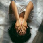 디지털 디톡스와 마음 챙김, 스트레스 시대의 새로운 건강 습관 a woman holds her hands over her face