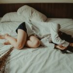 “일상이 힘들다면, 만성피로 자가 관리 루틴으로 활력 되찾기” woman lying on bed